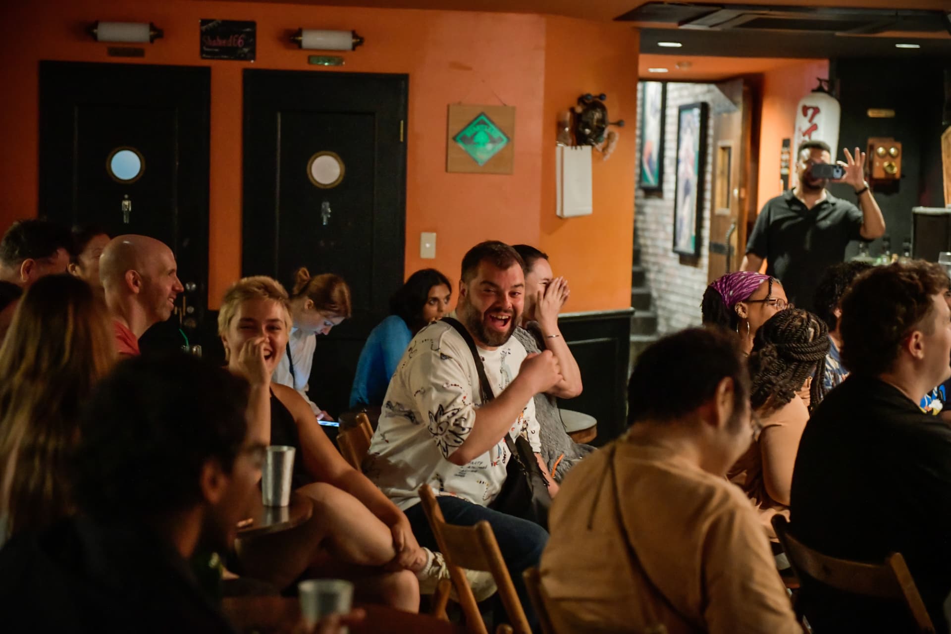 Audience laughing hard at a live English stand up comedy show at Ki Bar in Pontocho, Kyoto