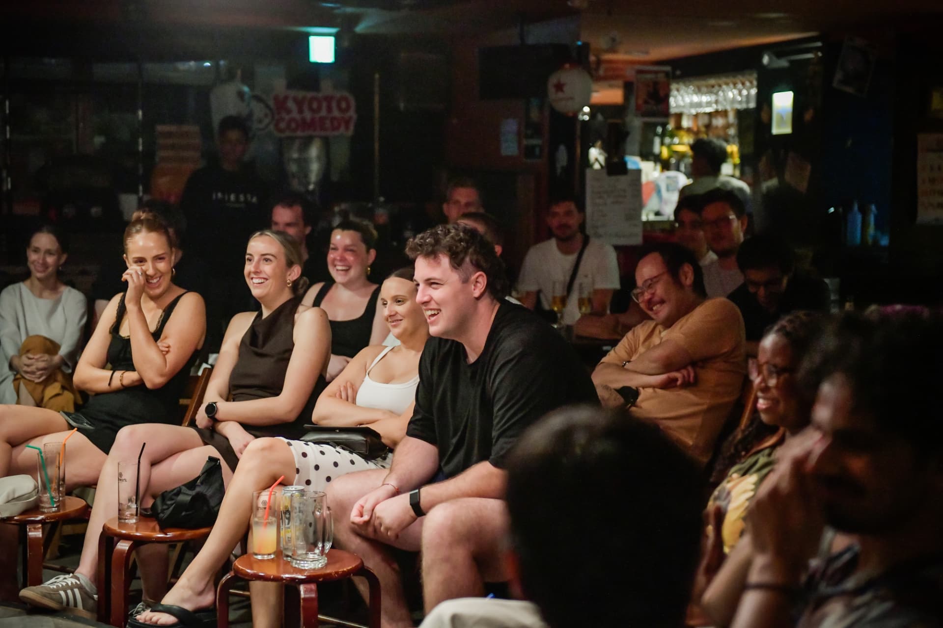 International audience laughing together during a Kyoto Comedy show