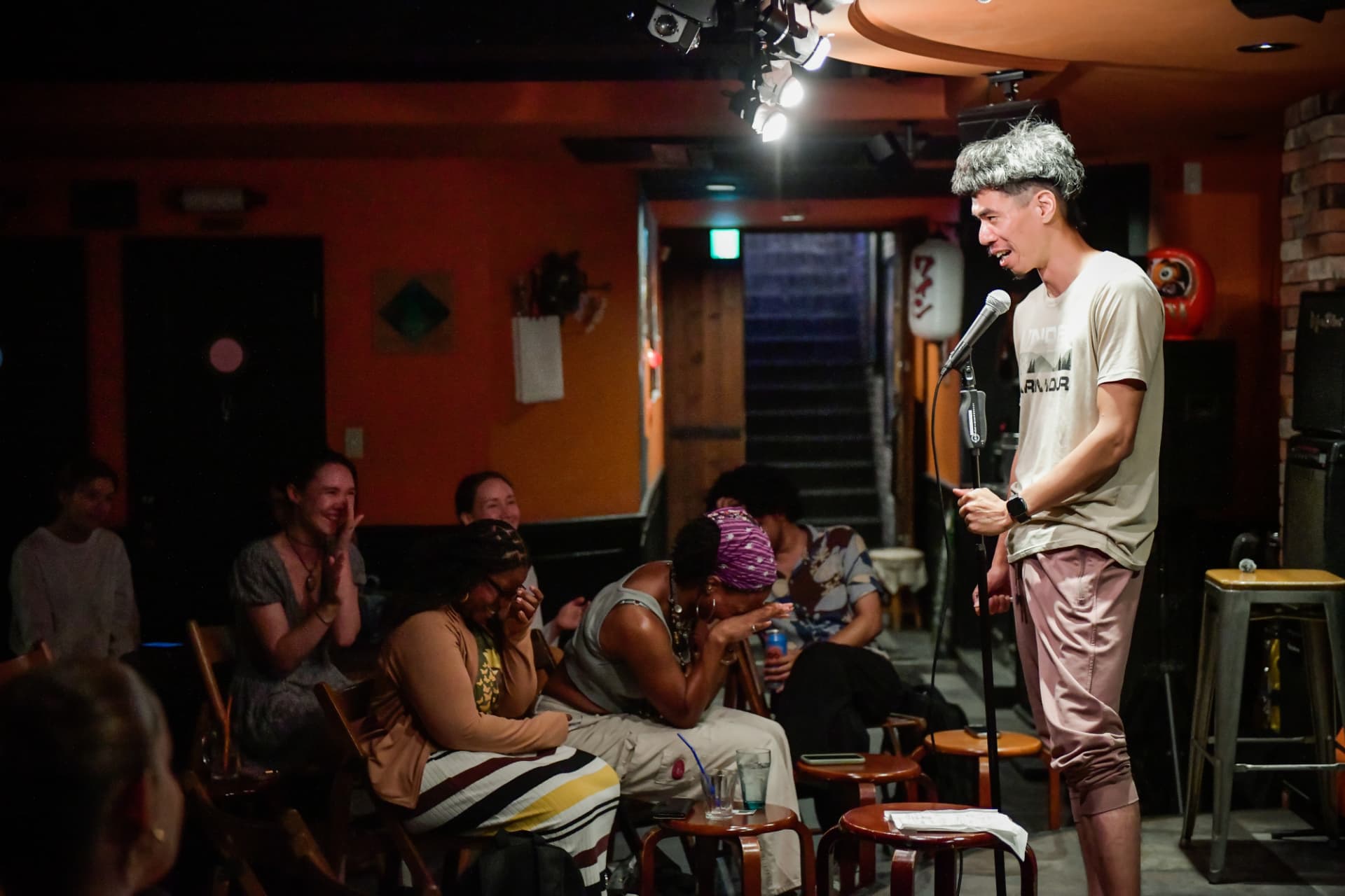 Comedian and audience laughing together at an English stand up comedy night in Kyoto